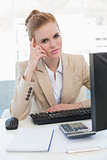 Worried businesswoman with computer at desk