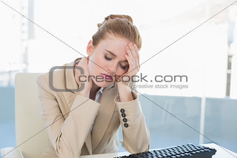 Businesswoman with neck pain at office desk
