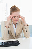 Businesswoman suffering from headache at office