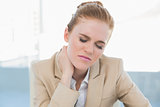 Close up of young businesswoman with neck pain