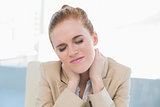 Close up of businesswoman with neck pain