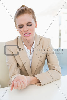 Businesswoman suffering from wrist pain