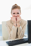 Worried businesswoman biting nails at office