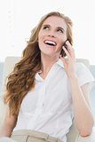 Cheerful businesswoman using cellphone