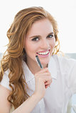 Portrait of smiling businesswoman with pen