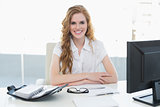 Smiling businesswoman with computer in office
