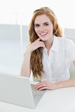 Beautiful businesswoman using laptop at desk