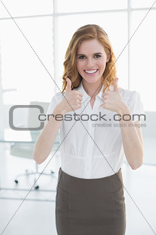 Smiling businesswoman gesturing thumbs up