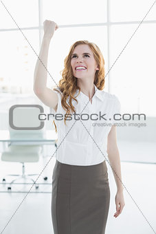 Cheerful elegant businesswoman cheering in office