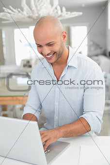 Casual man using laptop at home