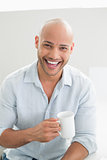 Portrait of a cheerful casual man drinking coffee