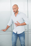 Casual young man with stomach pain at home