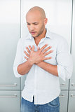 Casual young man with chest pain at home