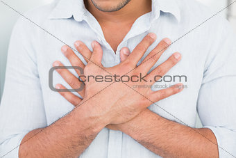 Mid section of man with chest pain