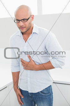Casual man suffering from chest pain at home