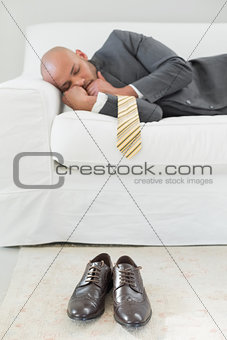 Elegant businessman sleeping on sofa