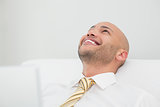 Close up of smiling elegant young businessman looking up