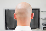 Extreme Close up of a bald man using computer