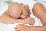 Close up of a young man sleeping in bed
