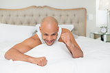 Close up of a man cheering in bed