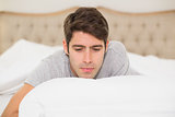 Close up of a young man resting in bed