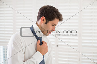 Businessman wearing tie in a hotel room