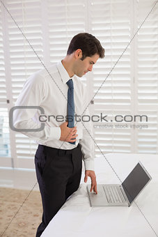 Businessman using laptop at a hotel room