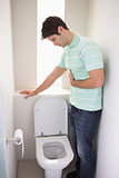 Man with stomach sickness about to vomit into the toilet