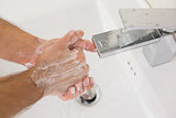 Washing hands with soap under running water