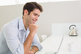 Casual young man using laptop at home