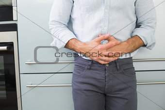 Mid section of a man suffering from stomach pain