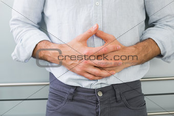 Mid section of a man suffering from stomach pain