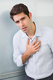 Portrait of a casual young man with chest pain