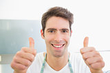 Close up of a smiling man gesturing thumbs up