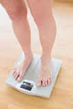 Close up of woman standing on weighing scale