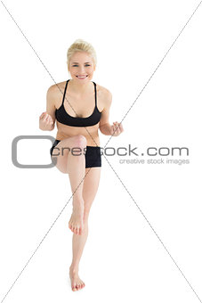 Full length portrait of a sporty young woman dancing