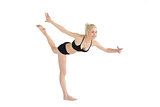 Full length of a sporty young woman balancing on one leg