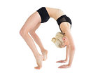 Side view of a fit young woman doing the wheel pose