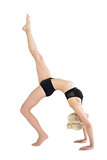 Fit woman doing the wheel pose with one leg raised