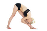 Full length of sporty woman bending down to her leg