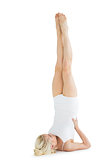 Fit young woman doing the shoulder stand pose