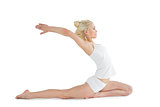 Toned young woman stretching hands backwards