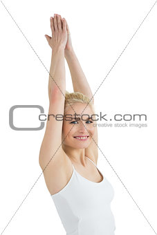 Portrait of a toned young woman with joined hands over head