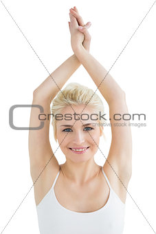 Sporty woman with twisted hands over head
