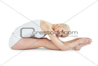 Toned woman doing the paschimottanasana pose