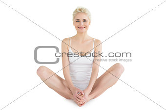 Toned young woman doing the butterfly stretch