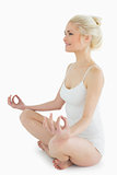 Toned young woman sitting in lotus position