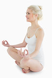 Full length of toned woman sitting in lotus position
