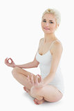 Full length portrait of toned woman sitting in lotus position