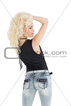 Rear view of a beautiful casual blond posing